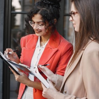 female-colleagues-discussing-data-cafe-outdoor-multiracial-female-persons-analyzing-productive-strategy-business-projecting-using-documents-street-cafe